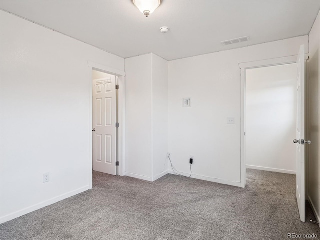 carpeted spare room with baseboards and visible vents