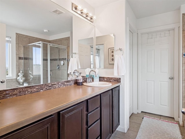 full bath with vanity, tile patterned flooring, a stall shower, and visible vents