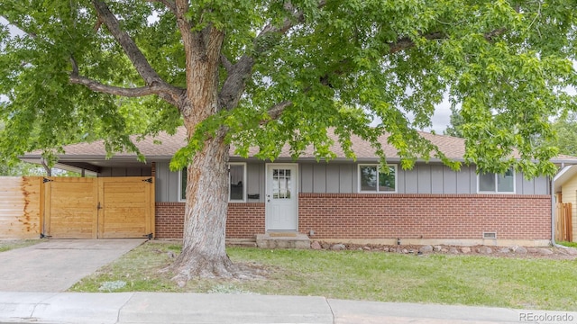 755 34th St, Boulder, CO 80303 - view of front of property with brick siding, board and batten siding, concrete driveway, a carport, and roof with shingles