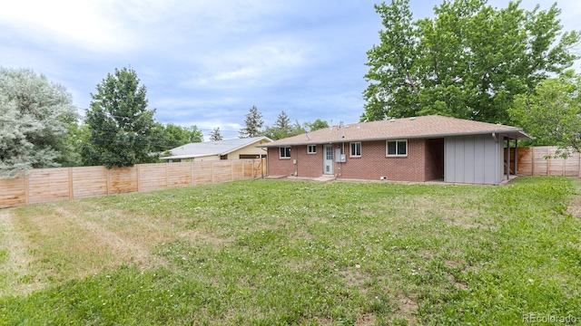 755 34th St, Boulder, CO 80303 - back of house with a fenced backyard, board and batten siding, and brick siding
