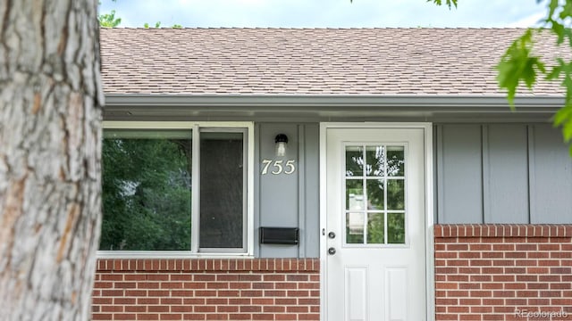 755 34th St, Boulder, CO 80303 - property entrance with a shingled roof, brick siding, and board and batten siding