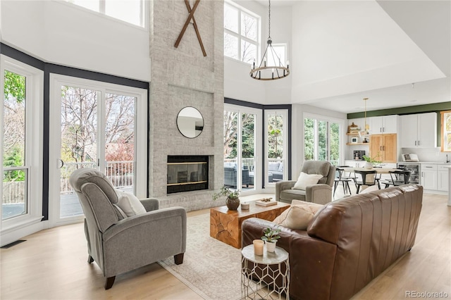 living room with a healthy amount of sunlight, a high ceiling, and visible vents