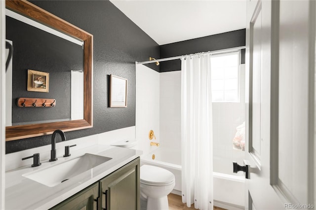 bathroom with vanity, a textured wall, toilet, and shower / bathtub combination with curtain
