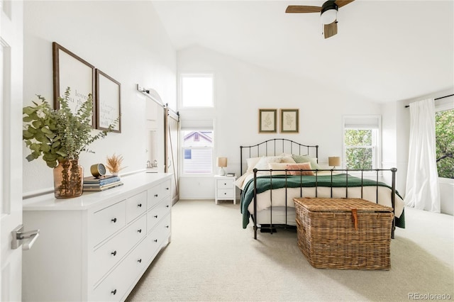bedroom with ceiling fan, light carpet, and vaulted ceiling