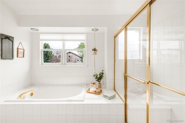 full bathroom with a shower stall and a garden tub