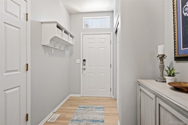 doorway to outside with light wood finished floors