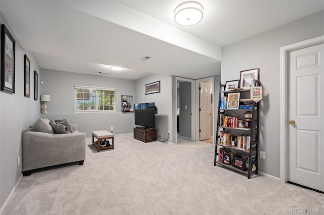 carpeted living room with baseboards