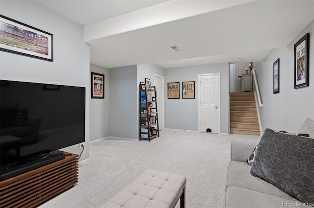 carpeted living room featuring stairway and baseboards