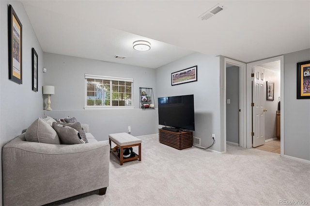 carpeted living area with baseboards
