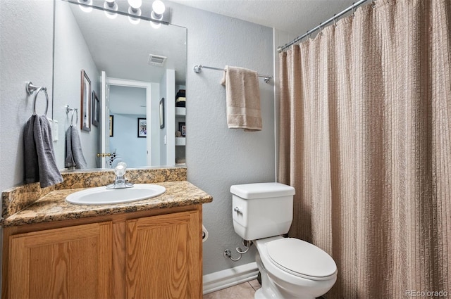 full bathroom featuring toilet, vanity, a textured wall, and curtained shower