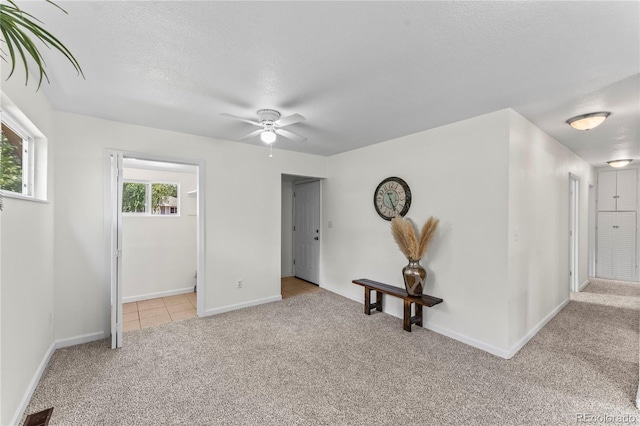 134 Hayes Dr, Colorado Springs, CO 80911 - carpeted spare room with a ceiling fan, a textured ceiling, and tile patterned floors