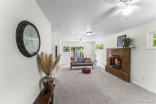 134 Hayes Dr, Colorado Springs, CO 80911 - living room with a ceiling fan, carpet floors, plenty of natural light, and a tile fireplace