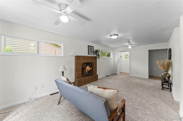 134 Hayes Dr, Colorado Springs, CO 80911 - living area with ceiling fan, carpet floors, and a tiled fireplace