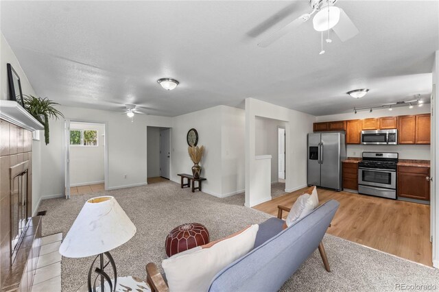 134 Hayes Dr, Colorado Springs, CO 80911 - living room with a ceiling fan, light carpet, and track lighting