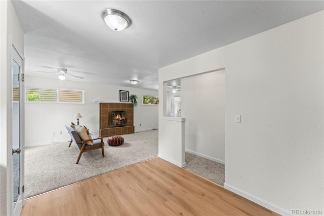 134 Hayes Dr, Colorado Springs, CO 80911 - sitting room featuring ceiling fan, a fireplace, and wood finished floors