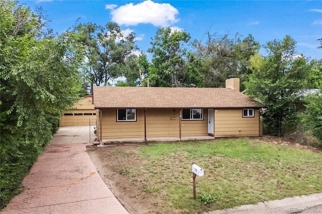 134 Hayes Dr, Colorado Springs, CO 80911 - ranch-style home with driveway, an attached garage, a chimney, a front lawn, and a shingled roof