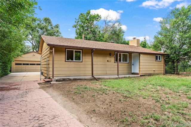 134 Hayes Dr, Colorado Springs, CO 80911 - ranch-style home featuring a chimney, an outbuilding, a garage, and roof with shingles