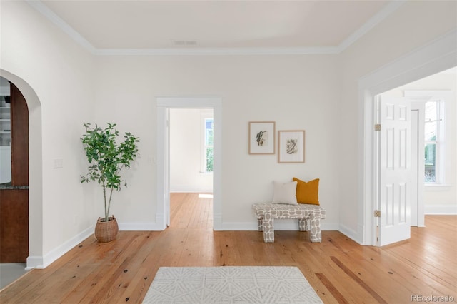 539 Baker St, Longmont, CO 80501 - living area featuring arched walkways, hardwood / wood-style floors, crown molding, and baseboards