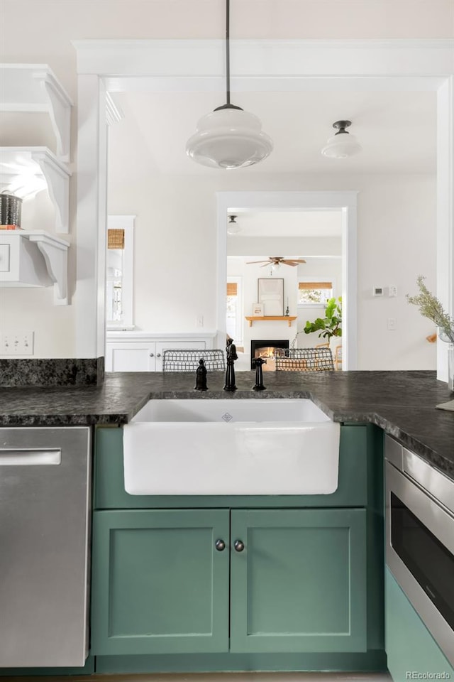 539 Baker St, Longmont, CO 80501 - kitchen featuring green cabinets, stainless steel appliances, a sink, ceiling fan, and hanging light fixtures