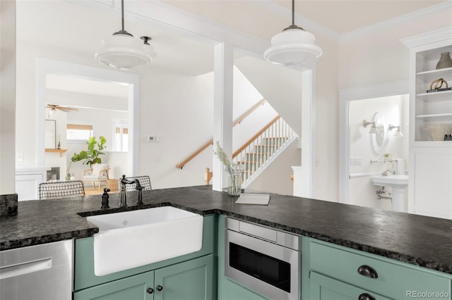 539 Baker St, Longmont, CO 80501 - kitchen with appliances with stainless steel finishes, dark countertops, green cabinetry, a sink, and hanging light fixtures