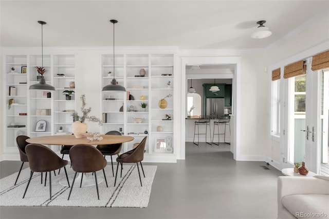 539 Baker St, Longmont, CO 80501 - dining space with crown molding, baseboards, and finished concrete floors
