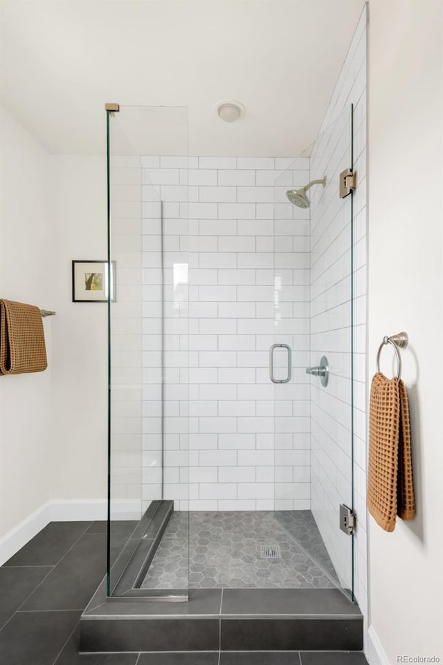 539 Baker St, Longmont, CO 80501 - bathroom with tile patterned floors, a shower stall, and baseboards