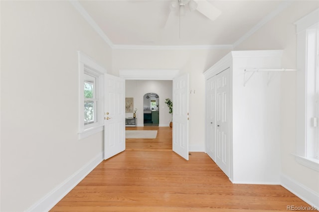 539 Baker St, Longmont, CO 80501 - hall with light wood-style floors, crown molding, arched walkways, and baseboards