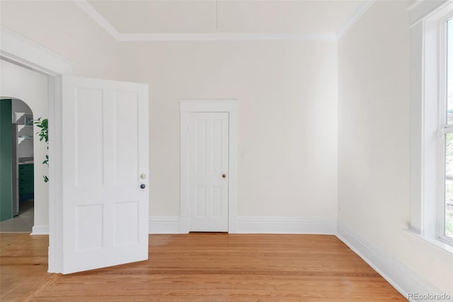 539 Baker St, Longmont, CO 80501 - unfurnished room featuring arched walkways, crown molding, light wood finished floors, and baseboards