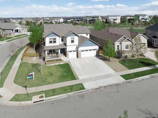 404 Dusk Ct, Erie, CO 80516 - view of front of house with a residential view, concrete driveway, an attached garage, and stone siding