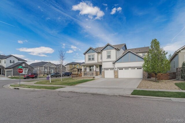 404 Dusk Ct, Erie, CO 80516 - craftsman-style house with stone siding, a residential view, driveway, an attached garage, and fence