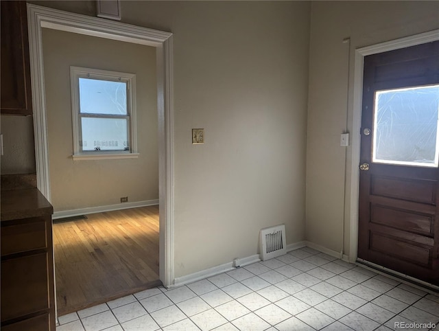 foyer entrance with light hardwood / wood-style floors