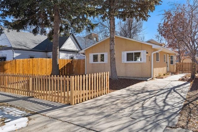 exterior space featuring a fenced front yard and stucco siding