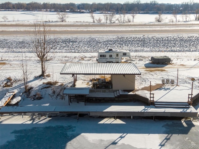 snowy aerial view featuring a rural view