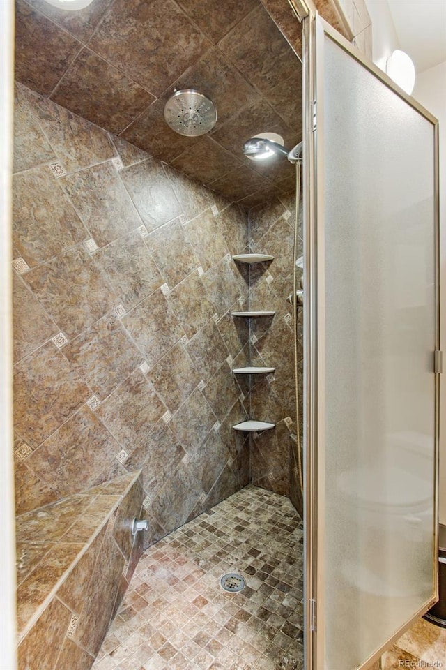 bathroom with a tile shower