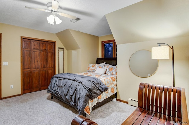 carpeted bedroom featuring a baseboard radiator, ceiling fan, and a closet