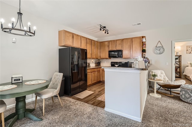 kitchen featuring visible vents, decorative light fixtures, a peninsula, black appliances, and open shelves