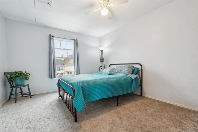 bedroom featuring carpet flooring, a ceiling fan, baseboards, and attic access