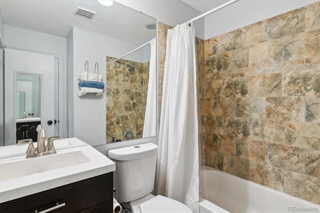 full bath with visible vents, shower / bathtub combination with curtain, toilet, and vanity