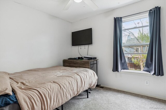 carpeted bedroom with baseboards and a ceiling fan