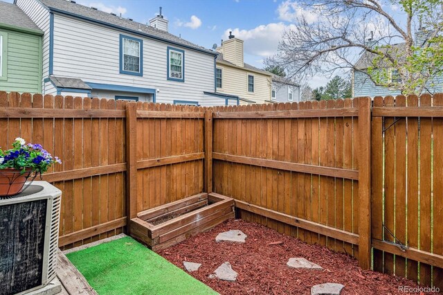 view of yard featuring fence and central AC unit
