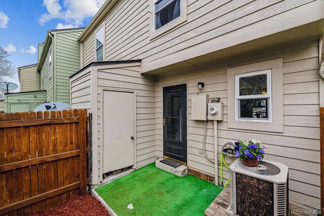 doorway to property featuring fence