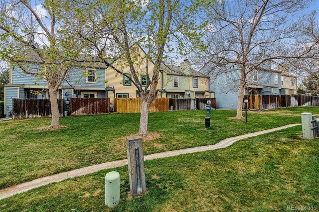 exterior space featuring fence and a front yard
