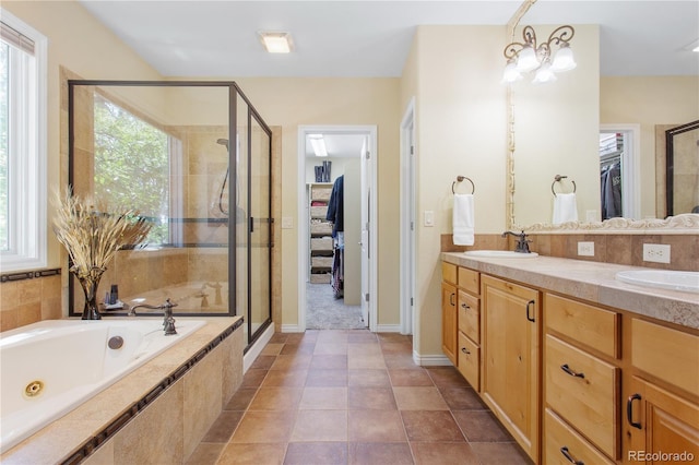 bathroom featuring tile patterned flooring, separate shower and tub, and dual bowl vanity