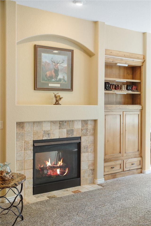 details with carpet flooring, a fireplace, and built in features