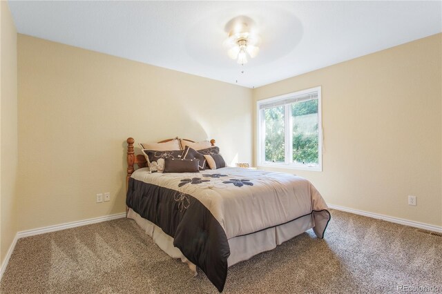 bedroom featuring carpet flooring, visible vents, and baseboards