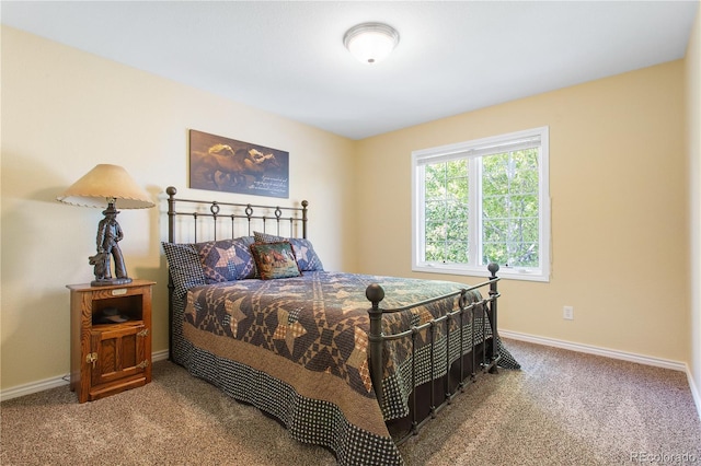 bedroom featuring baseboards and carpet flooring