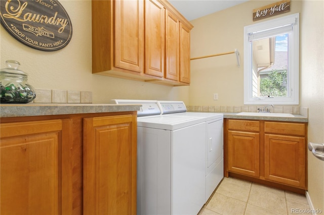 laundry area featuring a sink, cabinet space, washing machine and dryer, and light tile patterned floors