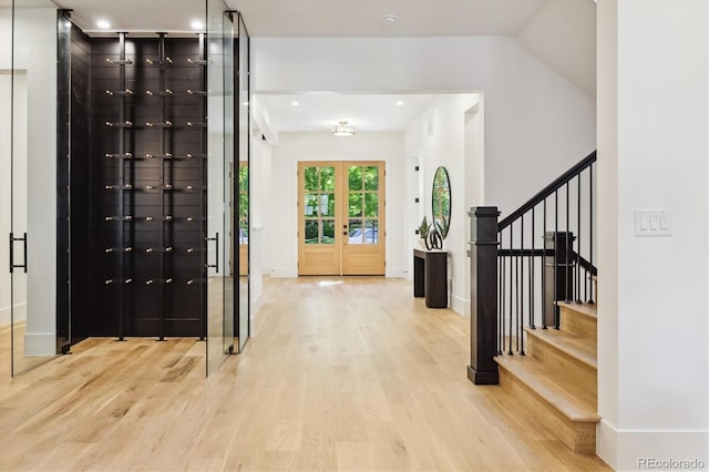 entrance foyer featuring french doors and light hardwood / wood-style flooring