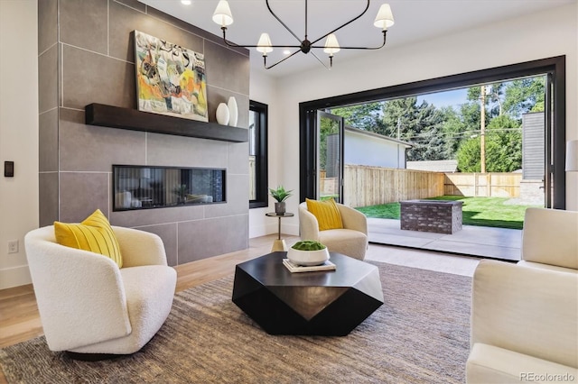 living room featuring a fireplace, a healthy amount of sunlight, and wood-type flooring