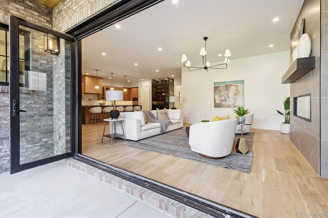 living room featuring light hardwood / wood-style floors and an inviting chandelier